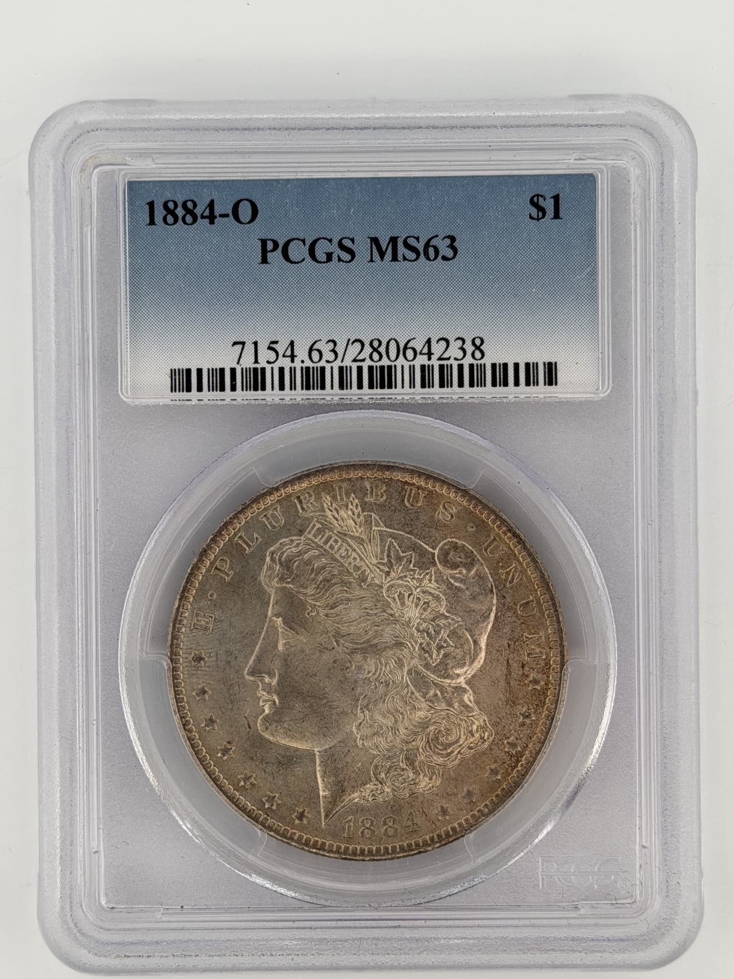 1884-O Morgan Silver Dollar PCGS MS63 obverse showing Lady Liberty portrait and E PLURIBUS UNUM legend in hard plastic slab
