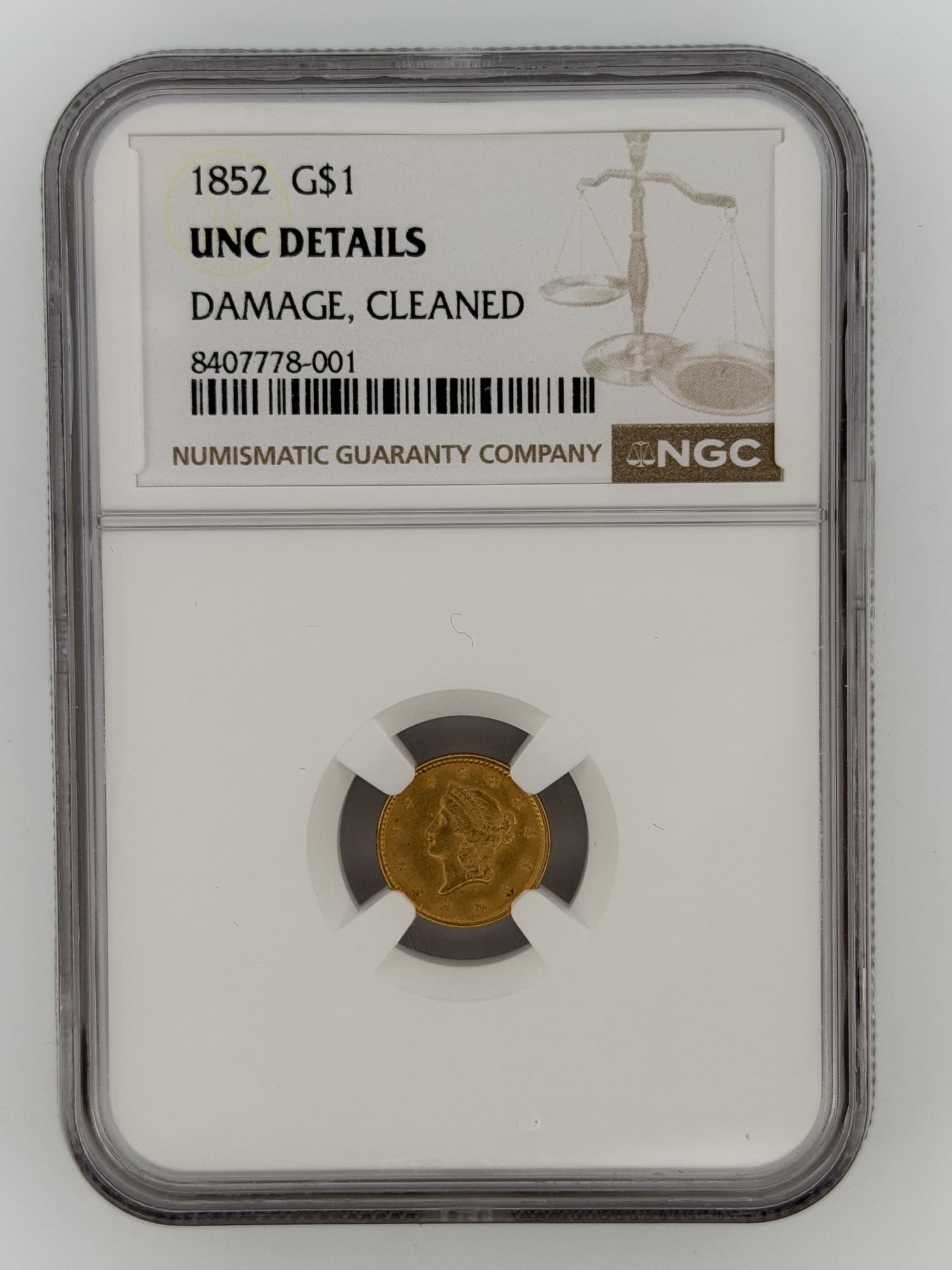 1852 Gold Dollar NGC UNC Details obverse showing Liberty Head portrait in NGC slab with grade label