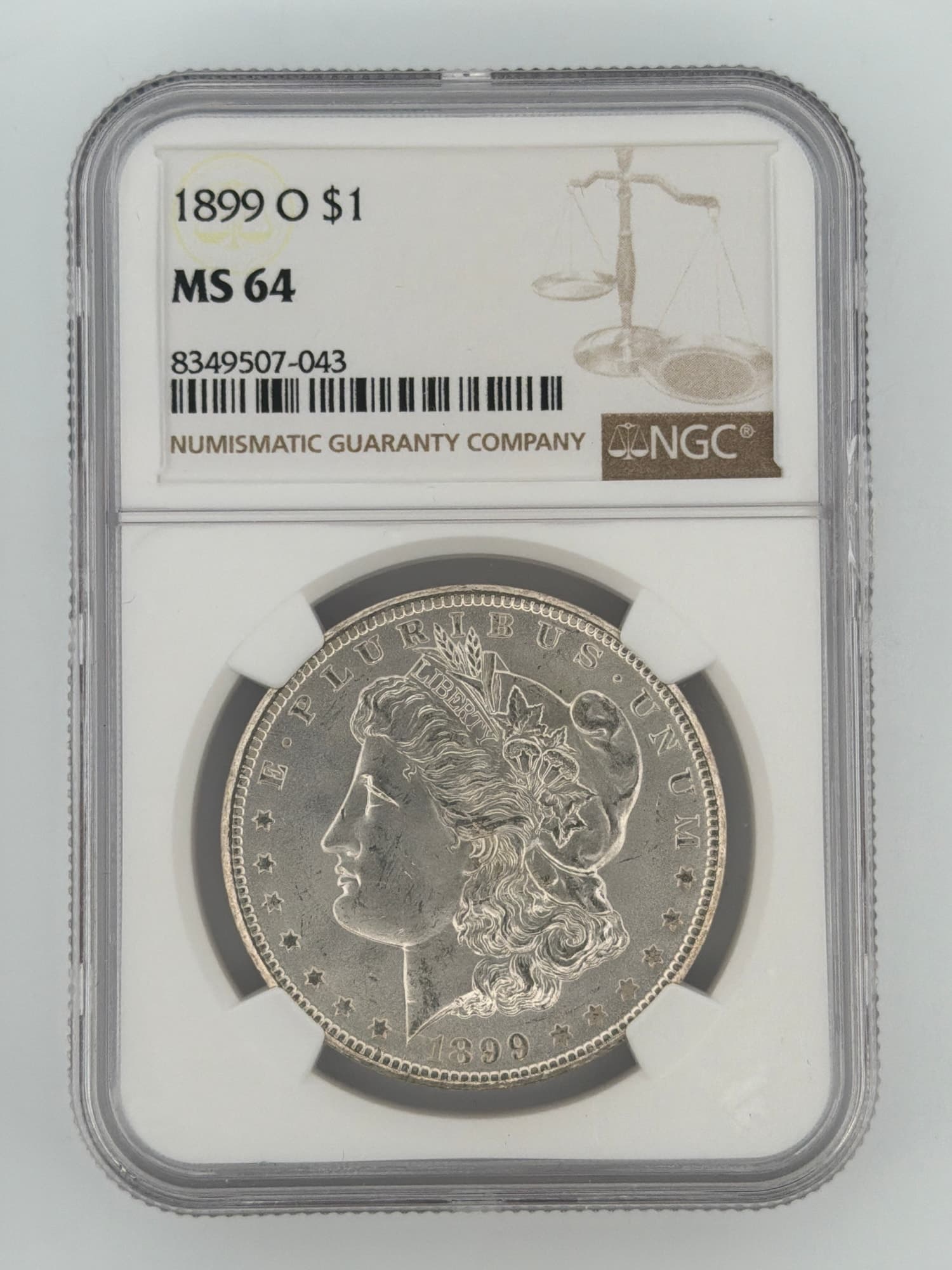 1899-O Morgan Silver Dollar NGC MS 64 obverse showing Liberty portrait and E PLURIBUS UNUM legend in NGC slab